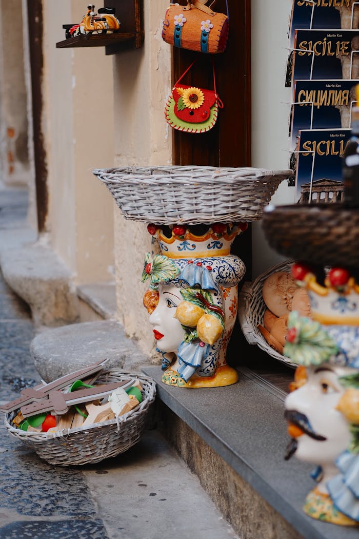Handmade ceramic vases and traditional Sicilian souvenirs on display in a street shop.